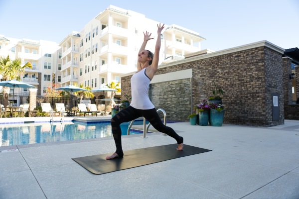 warrior pose - yoga 
woman, poolside doing yoga
