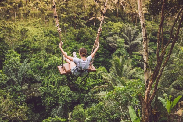 girl on swing in jungle