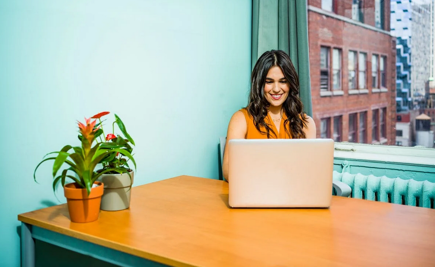 woman at desk with laptop computer